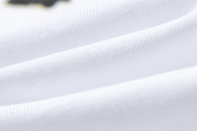 White Stussy Graphic T-Shirt with Skull, Dragon, and Floral Print