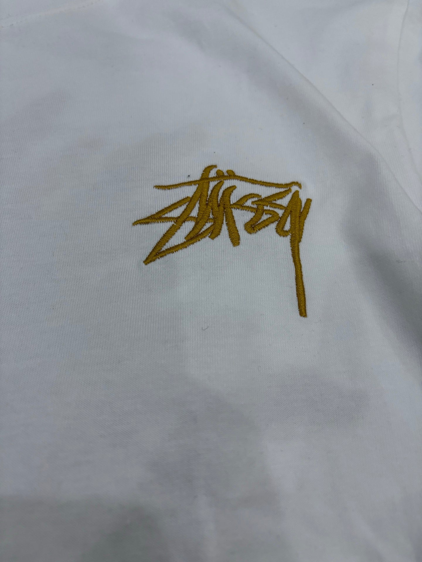 Stüssy White T-Shirt with Gold Chest Logo & Back Graphic