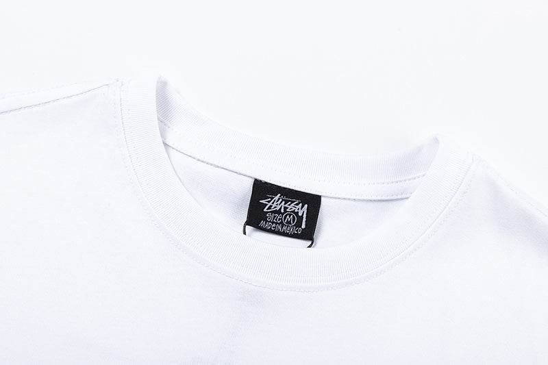 White Stussy Graphic T-Shirt with Skull, Dragon, and Floral Print